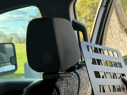 Headrest MOLLE panel attached to vehicle seat